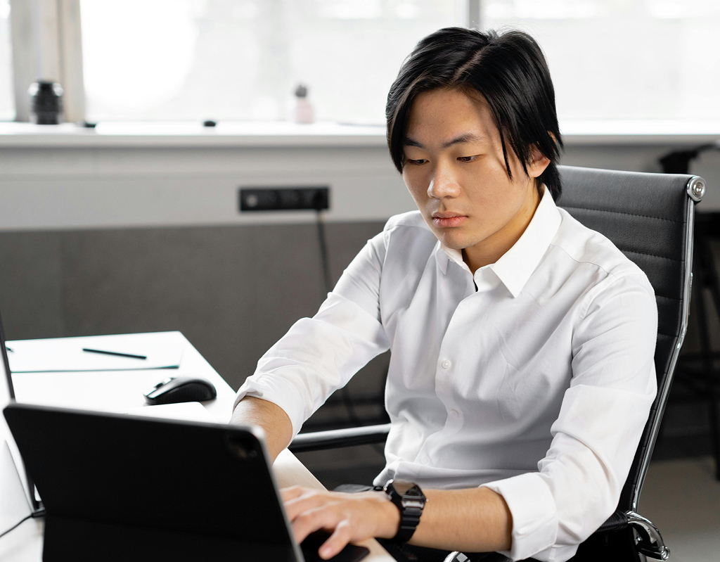 Offshore professional working on a laptop in a modern office environment